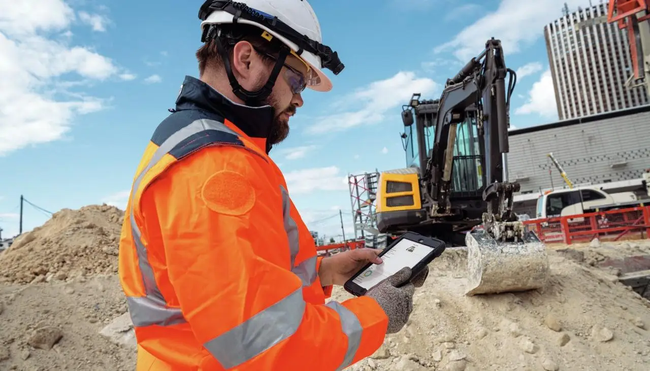 Construction worker using a pad while on a jobsite